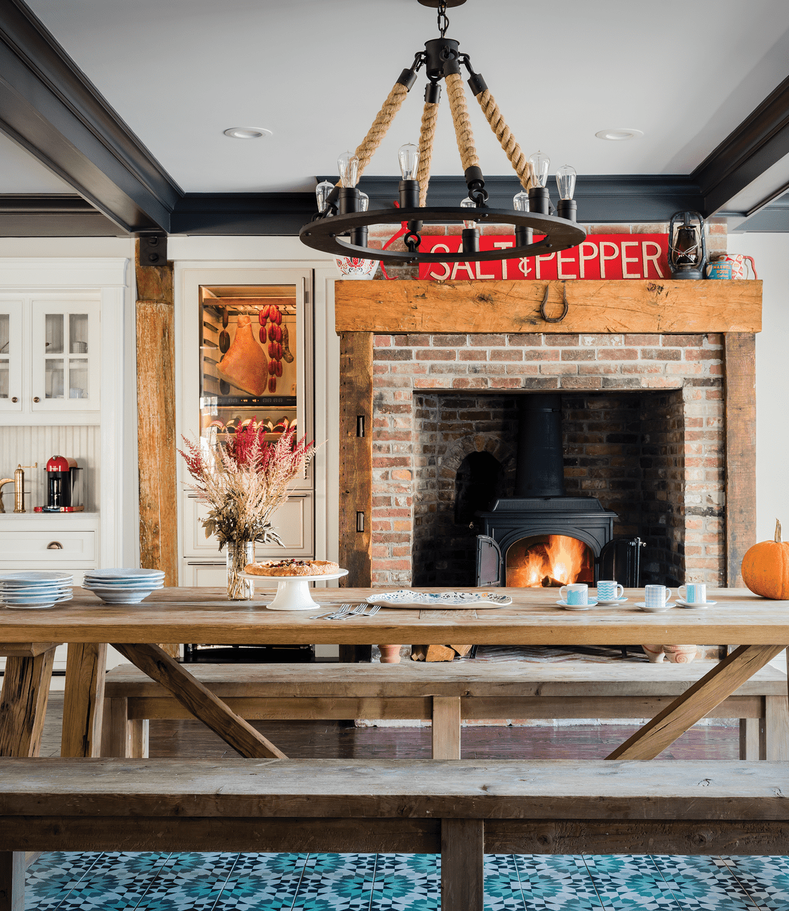 The kitchen addition marries old with new and reveals the passions and pastimes of the owners. Original fireplaces as well as chestnut posts and beams mix with new cabinetry, tile inlay floor, and modern charcuterie and coffee stations.